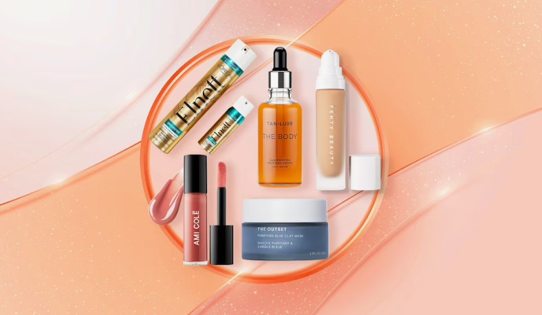 Beauty Products You Actually Need: A Minimalist Guide to Your Beauty Collection Alt text: A circular flat lay arrangement on a warm peach background featuring a curated collection of beauty products you actually need, including L'Oréal Elnett hairspray, Tan-Luxe body tanner, Fenty Beauty foundation, Ami Cole liquid lipstick, and The Outset blue clay mask.