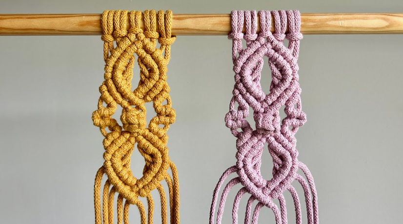 Two mustard yellow and dusty pink macrame wall hangings featuring intricate knot patterns on a wooden rod, highlighting simple crafts for people who arent artistic.