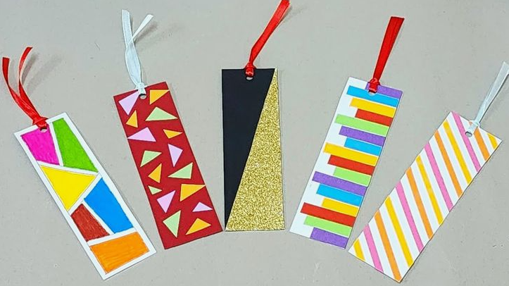 A set of five colorful handmade paper bookmarks featuring geometric designs, stripes, and ribbon tassels, showcasing creative home decor ideas without buying anything.