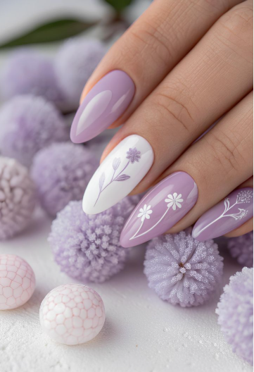 30 Classy Nail Colors for Mature Hands Hands showcasing classy nail colors for mature hands, featuring glossy lilac oval nails and a white accent nail adorned with delicate floral botanical art.