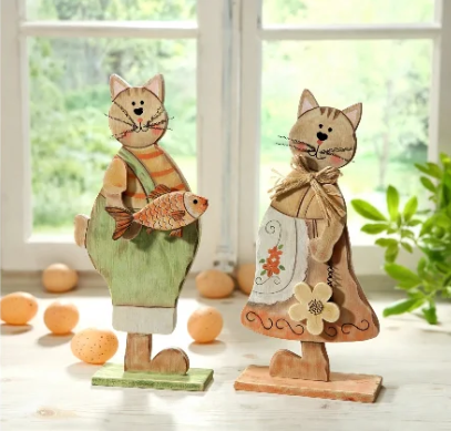 20 Retro Crafts to Try for a Creative Weekend Pair of freestanding rustic wooden cat figurines displayed on a windowsill, featuring a painted boy cat in green overalls holding a fish and a girl cat wearing a floral apron with a burlap bow, illustrating handmade retro crafts home accents.