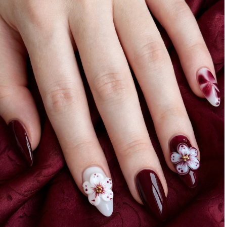 Elegant deep burgundy and white almond manicure showcasing easy 3D nail art designs with sculpted cherry blossom acrylic flowers accented by gold bead centers.