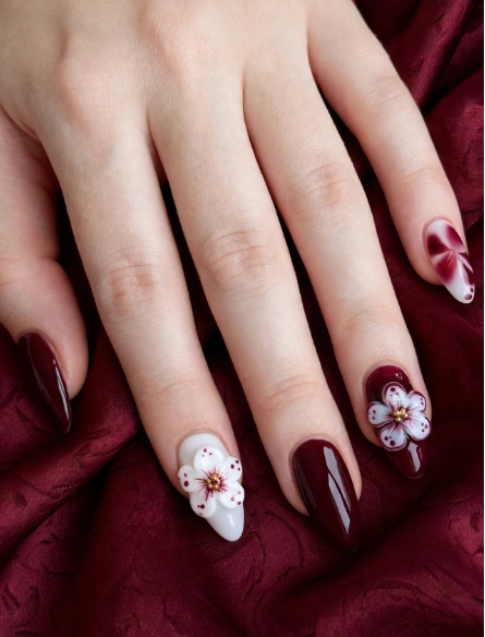 Elegant deep burgundy and white almond manicure showcasing easy 3D nail art designs with sculpted cherry blossom acrylic flowers accented by gold bead centers.