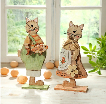 20 Retro Crafts to Try for a Creative Weekend Pair of rustic wooden cat figurines featuring a painted boy cat holding a fish and a girl cat with a floral apron and twine bow, displaying charming retro crafts home decor.