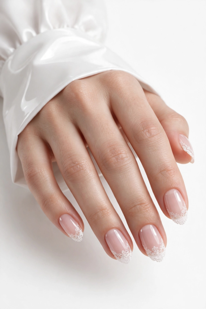 Nails Inspo 2026: 30+ Trendy Nail Ideas to Save Nails inspo 2026 showcasing delicate white lace French tips on glossy nude almond nails.