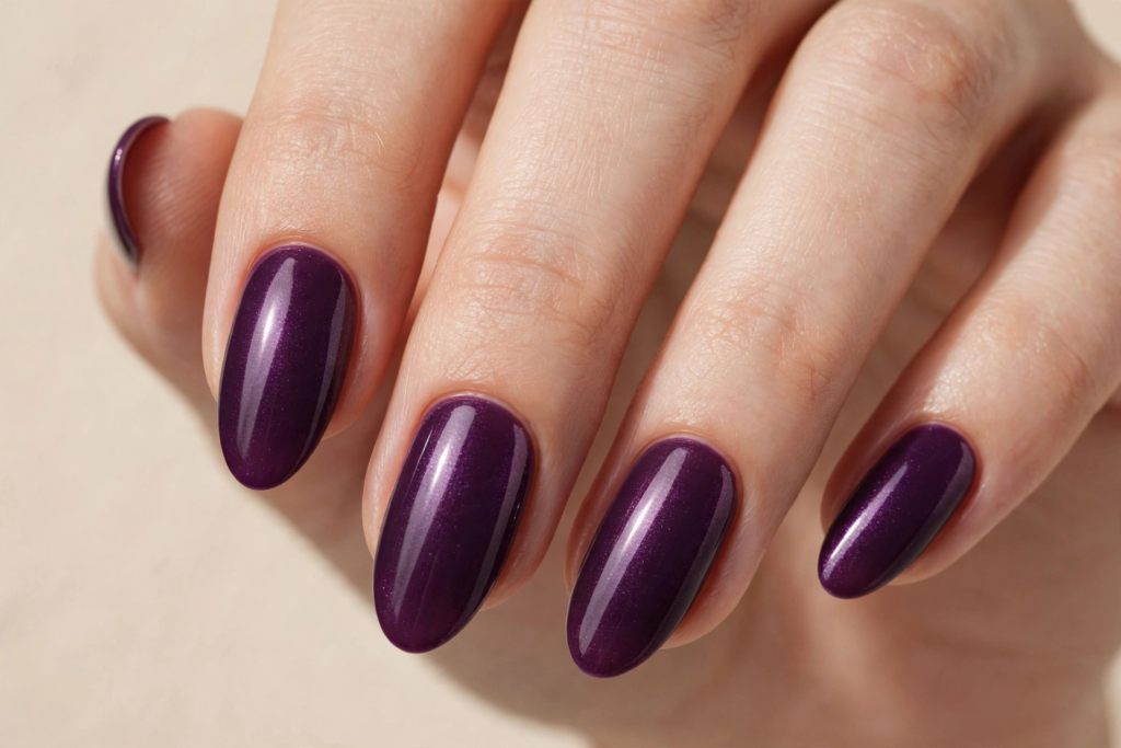 Fall nail inspo 2026 featuring glossy deep eggplant purple oval nails with a subtle fine shimmer.   