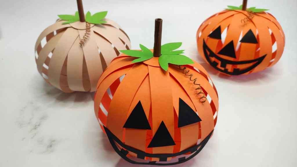 3D paper strip pumpkins and jack-o'-lanterns craft, an easy Halloween idea for fall crafts for kids.